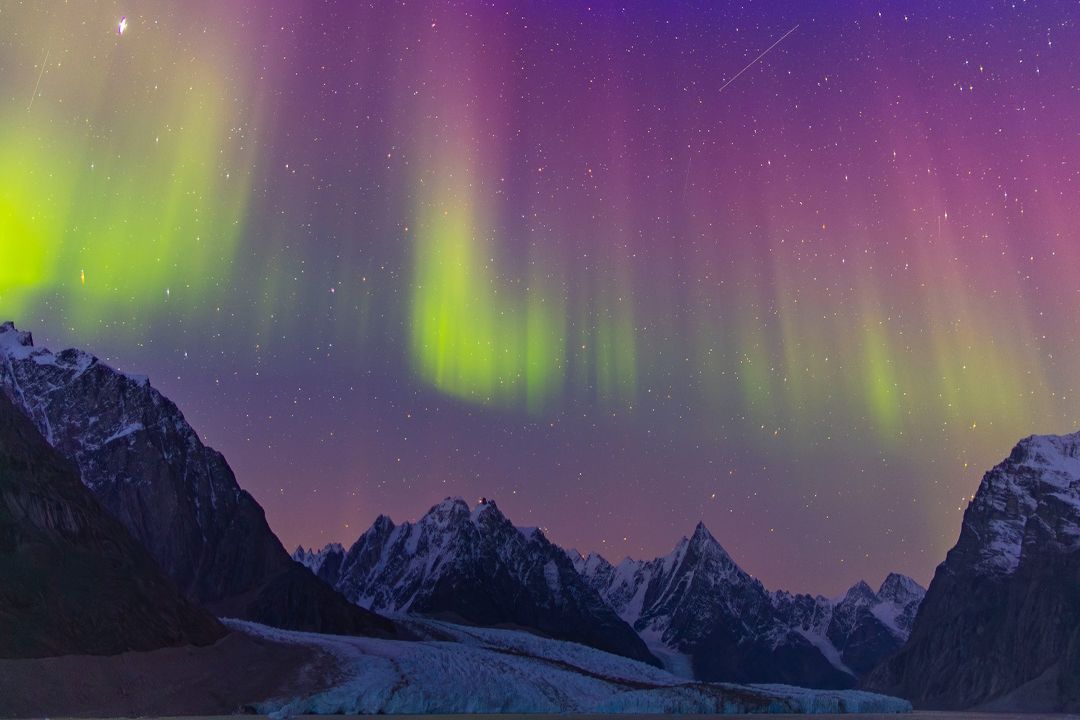 Northern Lights above a coastal landscape